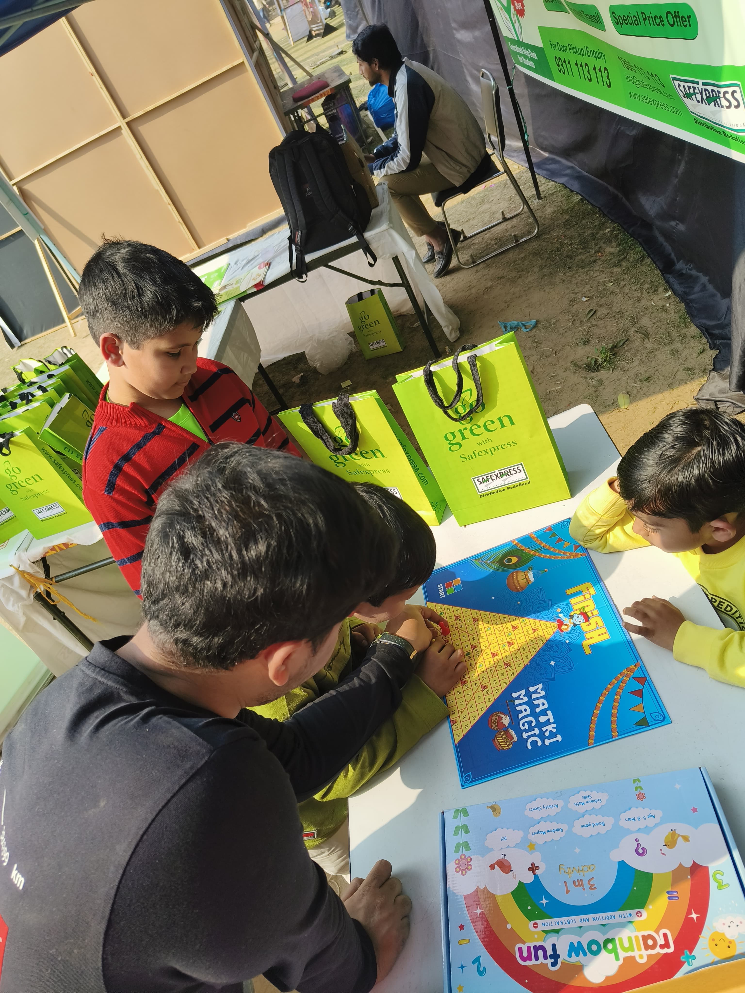 Kids gathered around a BoredomBox board game